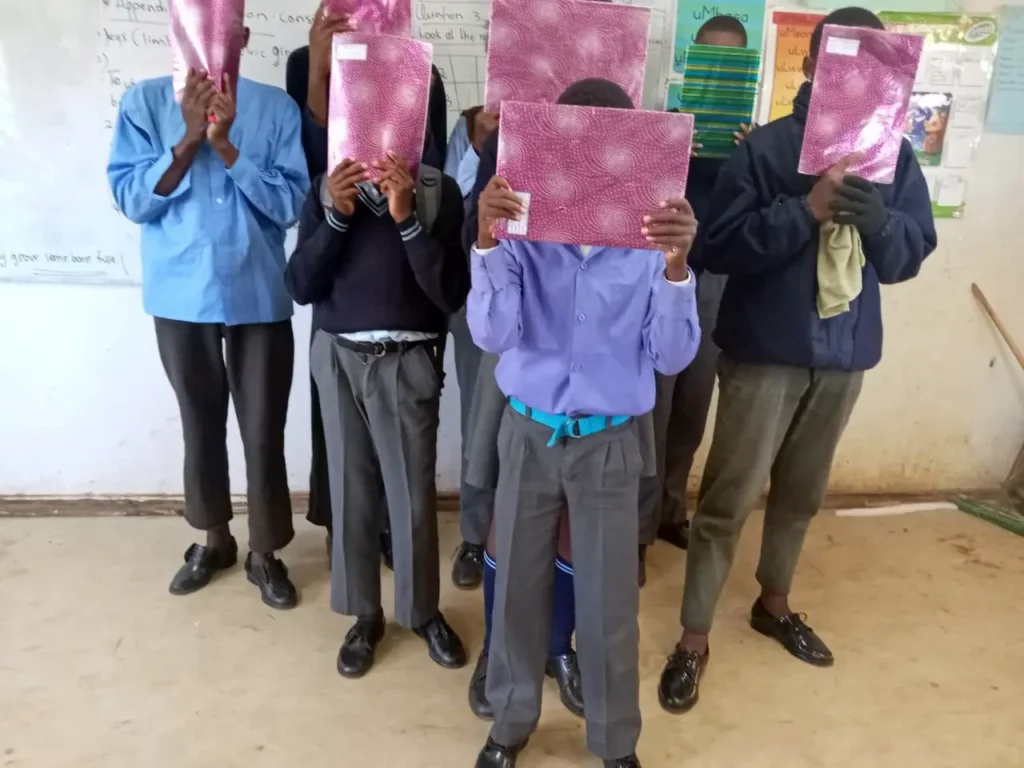 SIZANANI CSI project, donation of school shoes, sanitary pads and stationery to 300 underprivileged children.
